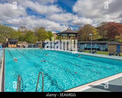 Hathersage outdoor swimming pool with swimmers and bandstand, Peak District National Park, Derbyshire, England, UK. Stock Photo