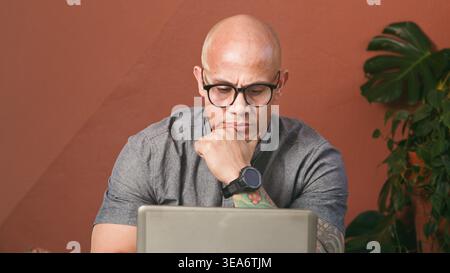 Focused Professional Man Working On Laptop For Business Planning And Remote Work Stock Photo