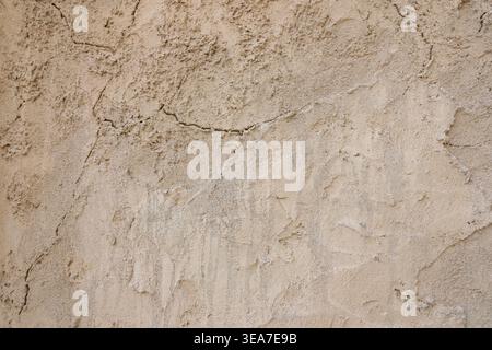 Authentic sandstone wall texture with aged surface and handmade plaster. Warm neutral background for modern design, interfaces, websites and luxury br Stock Photo