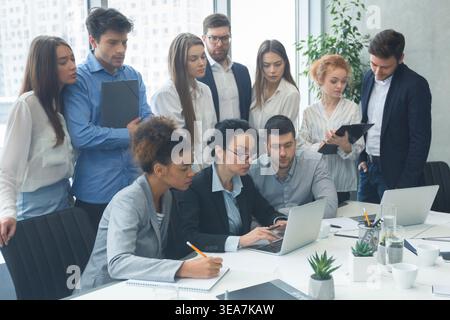 Corporate businesspeople using laptop and checking results of work Stock Photo