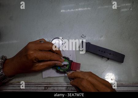 Top view of a man repairing a watch in his workshop. Stock Photo