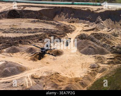 Aerial open pit sand and gravel mine with terraced cut walls Stock Photo