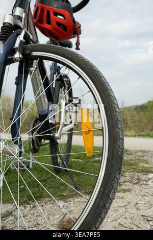 Orange spoke reflector on a bicycle wheel close up. Stock Photo