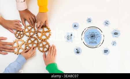 A dynamic overhead view showcasing diverse hands interacting with wooden gears. The image symbolizes collaboration in business and the integration of Stock Photo