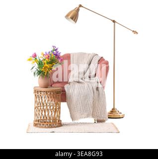 Vase with beautiful flowers on table, pink armchair and floor lamp isolated on white background Stock Photo