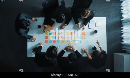 Top down aerial view startup team sharing marketing idea by using sticky notes. Professional diverse business group discuss brainstorm and planning Stock Photo