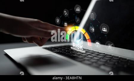 Digital Touch on Laptop Screen for Risk Management Concept with Various Icons and Graphs in Dark Background Sigmoid Stock Photo