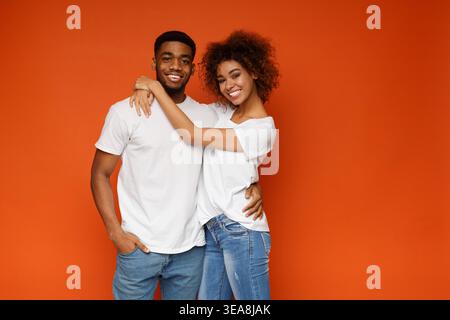 Cheerful african american man and woman embracing Stock Photo