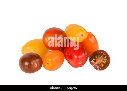 Heap of assorted mini grape and cherry tomatoes in various colors isolated cutout on white background. Fresh produce composition ideal for food design Stock Photo