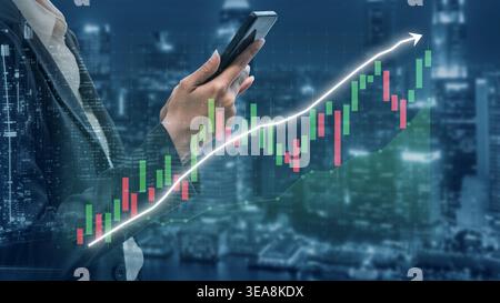 Business professional engages with stock market data on a smartphone, showcasing a glowing upward graph against a vibrant city skyline at night Stock Photo