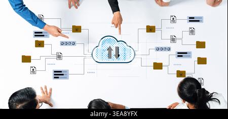 A diverse business team collaborates on a cloud computing strategy, illustrating data flow and innovative ideas for the future of digital Stock Photo
