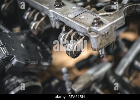 Close-up shot of the internal mechanics of an engine, showcasing the intricate details of its components. Focus on the rocker arms, bolts, and other p Stock Photo
