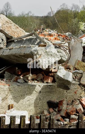 Pile of broken concrete and bricks from a demolished building showing texture and construction waste materials. Stock Photo
