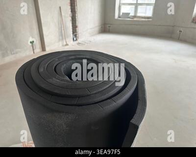 Roll of rubber foam insulation indoors, closeup Stock Photo
