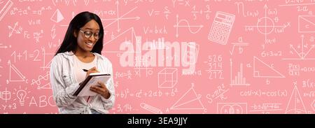 Student Writing Notes While Learning Math Concepts in a Classroom Setting With a Pink Background Stock Photo
