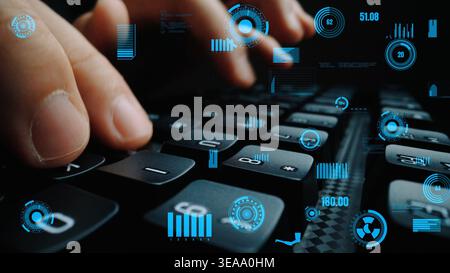 Close-up view of hands typing on a keyboard surrounded by futuristic data visualizations and graphs. This image conveys themes of technology Stock Photo