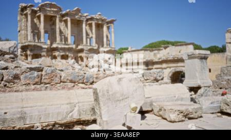 Ancient stone ruins softly defocused outdoor background with blurred columns and arch forms, warm sunlit tones; backplate template calm. Stock Photo