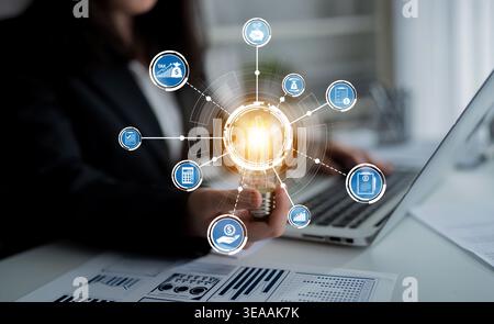 This image showcases a business professional integrating technology with various digital icons. It reflects innovation and data analysis in a modern Stock Photo