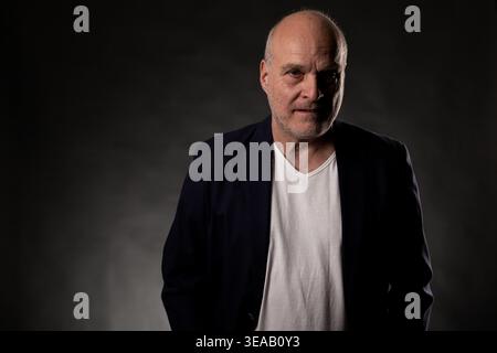Senior adult man wearing a casual suit jacket with his hands in pockets Stock Photo