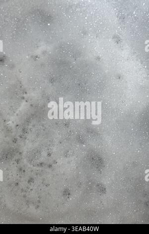 Soap suds create an organic, textured background that resembles a nebula scene from outer space. Stock Photo