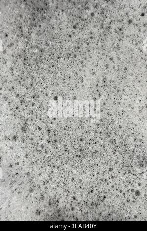 Soap suds foam and bubbles create an organic, textured background plate that resembles a scene from outer space or a sponge. Stock Photo