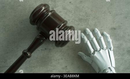 A top-down view of a wooden judge's gavel and a white robotic hand. Stock Photo