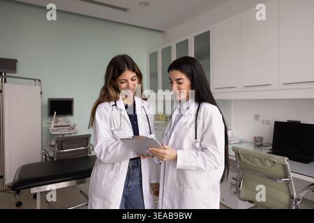 Two physicians working together on report using digital tablet Stock Photo