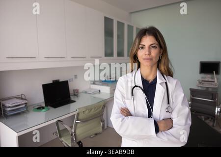 Portrait of Hispanic female doctor in white lab coat Stock Photo