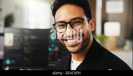 Portrait, programmer and man in office, smile and software development for website launch. Employee, programming and person in workplace, coding and Stock Photo