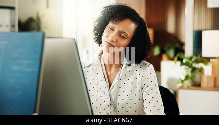 Woman, computer and happy with review at office for software development, notes or insight at tech company. Person, programmer and smile with project Stock Photo