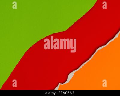A vibrant and colorful background featuring layers of torn paper in green, red and orange. Stock Photo