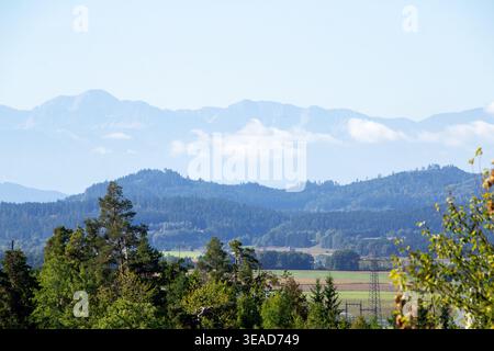 Cumulus clouds above the mountain ridge at the horizon. Vistara in the Gurktal valley, Carinthina, Austria, near Althofen. Stock Photo