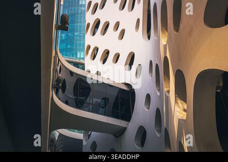 12 January 2026, Dubai, UAE: O-14 Contemporary architectural design featuring an organic pattern of irregularly shaped openings with glass bridge Stock Photo