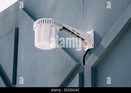 Outdoor wireless access point mounted on building wall providing public Wi-Fi coverage in urban environment Stock Photo