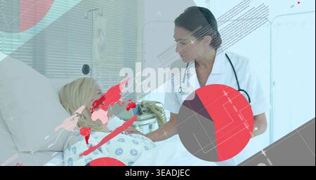 Leaning nurse in white uniform checking patient in patterned gown on hospital bed, IV, data overlay Stock Photo
