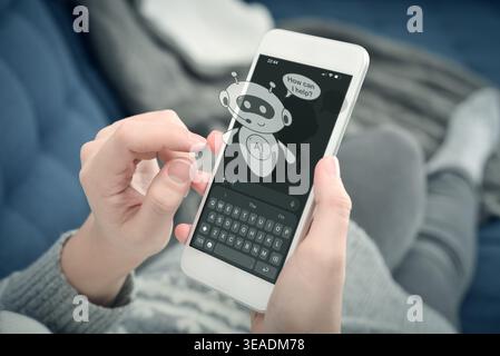 Close-up of woman hands holding smartphone at home. AI assistant chatbot on the screen with message “How can I help?”. Concept of virtual support, art Stock Photo
