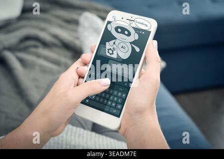 Woman holding smartphone with AI assistant hologram showing loading or thinking process. Concept of chatbot processing, artificial intelligence respon Stock Photo