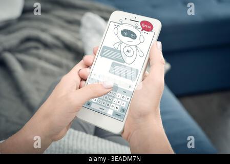 Close-up of woman holding smartphone with AI assistant hologram showing error message. Concept of chatbot failure, artificial intelligence problem, mo Stock Photo