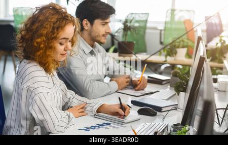 Colleagues Collaborating on Project in Modern Workspace With Natural Light Stock Photo