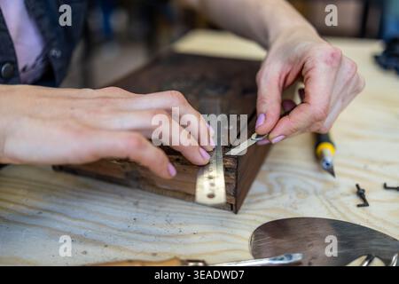 Restoring Decorated Wooden Box with Hand Tools on Workbench Stock Photo