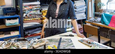 Seamstress working with fabrics in a tailor's workshop Stock Photo