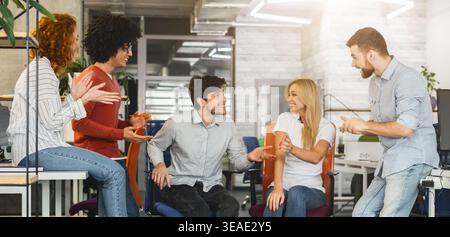 Engaging Team Discussion Among Colleagues in a Modern Office Setting Stock Photo
