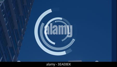 Displaying concentric HUD-style graphic hovering over clear blue sky, with high-rise facade Stock Photo