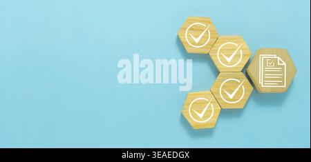 Quality Control Checklist and Approval Process Concept with Check Mark Icons and Document Symbol on Wooden Blocks over Blue Background. Stock Photo