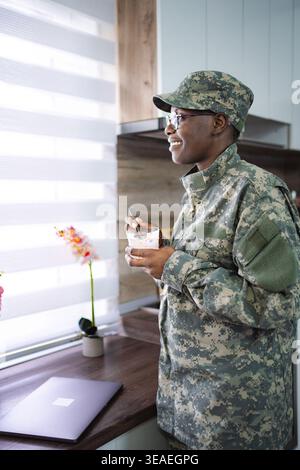 Smiling african american soldier enjoying breakfast in kitchen Stock Photo
