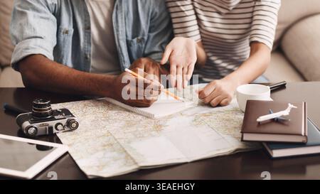 Couple planning vacation, making notes in diary Stock Photo