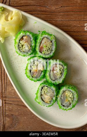 Sushi rolls with green coating and ginger Stock Photo