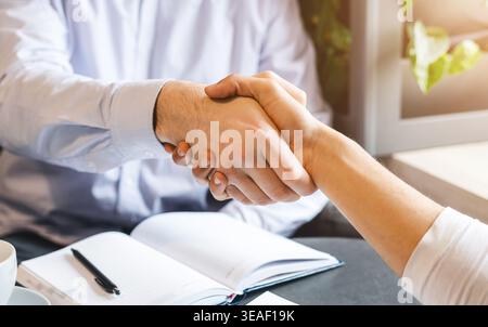 Handshake of two businessmen during lunch break Stock Photo