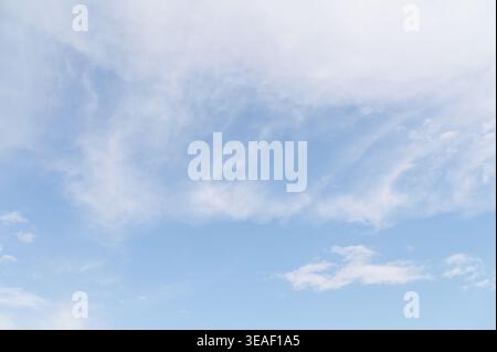 Wispy clouds and blue sky overhead during a calm morning in the spring season Stock Photo