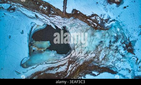 Aerial Frozen Waterfall and Snowy Landscape Top Down Winter Scene Stock Photo